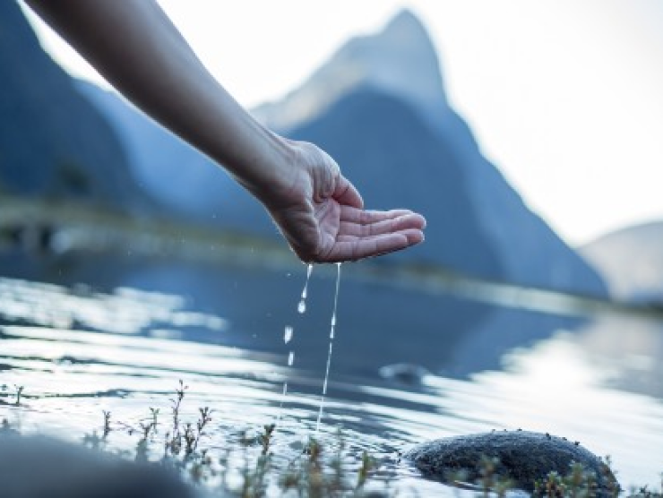 Hand in lake water